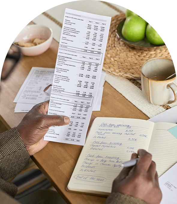 Hand holding a receipt over notebook