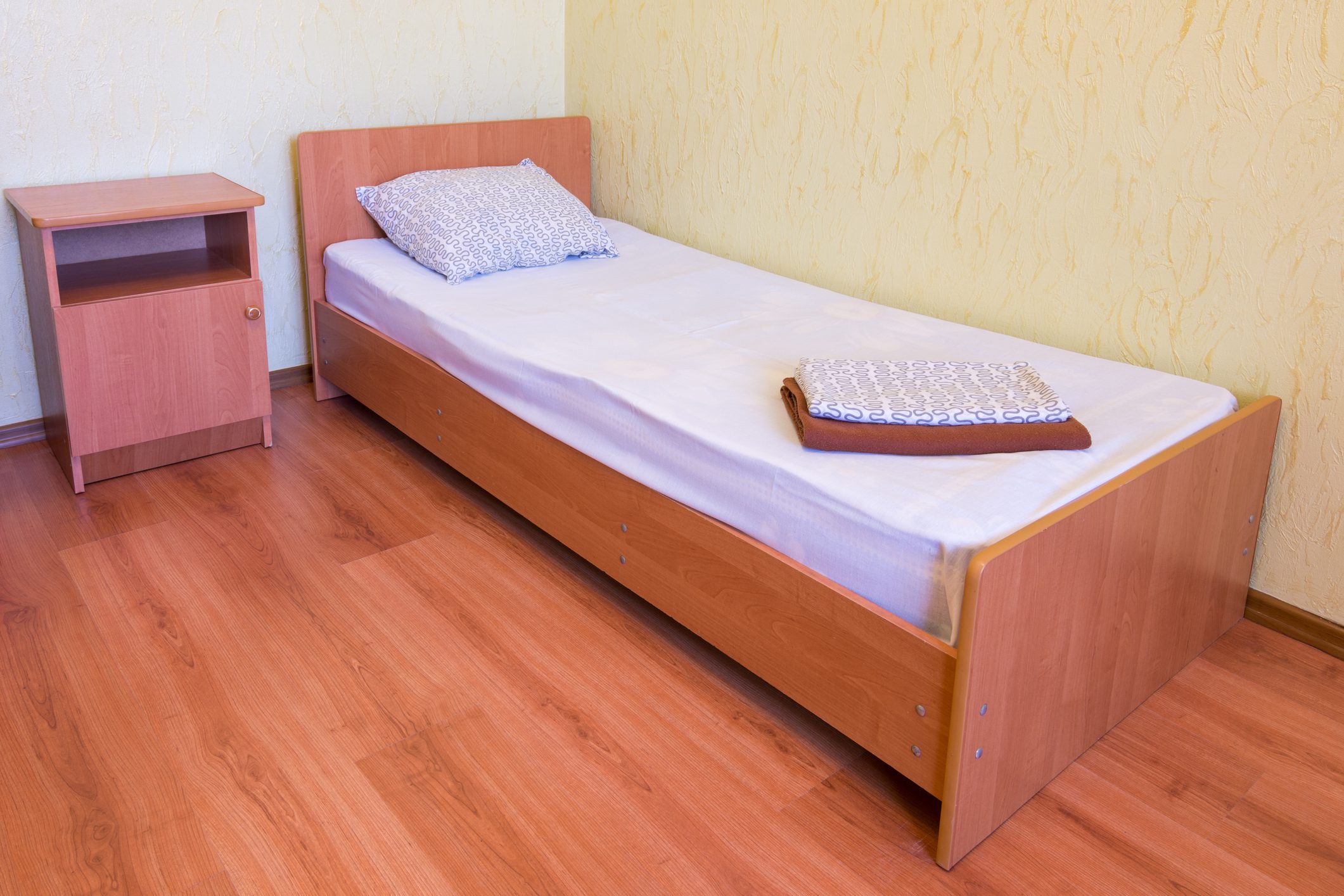 Sleeper - a bed and a bedside table in the interior of the room, close-up